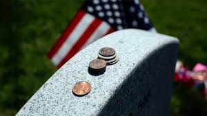 The Meaning Behind Coins on Veterans' Tombstones: A Silent Tribute
