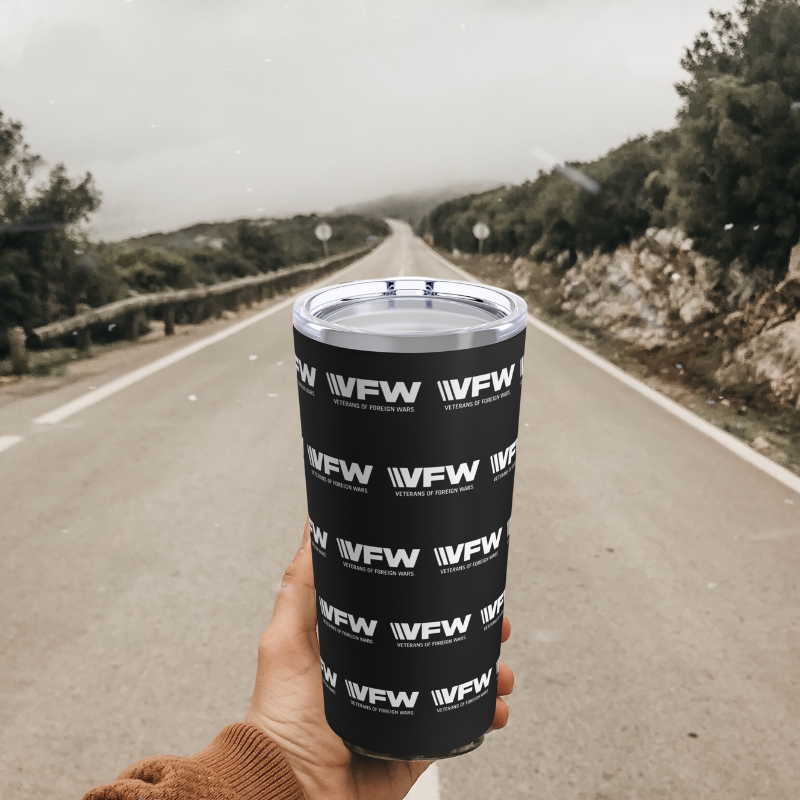 Alt image text: "Man holding VFW durable 20 oz tumbler while hiking, showcasing the tumbler's sturdy stain
